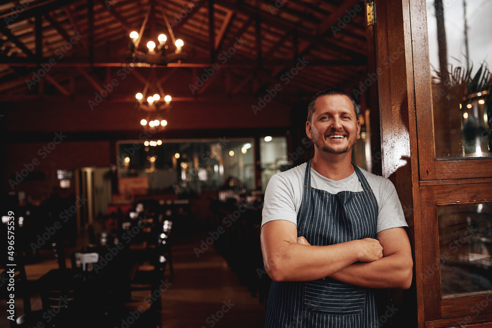 The master taking a break. Portrait of a confident middle aged business owner standing with arms fol