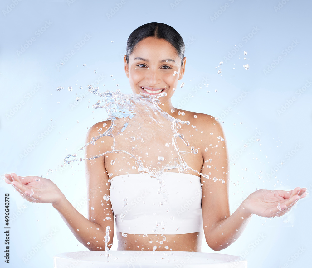 Your skin is 90 of your selfie. Shot of a young woman washing herself against a blue background.