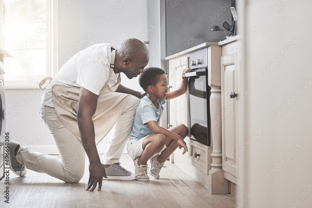 Its so much fun to mix all the ingredients. Shot of a father and son standing by the oven in the kit