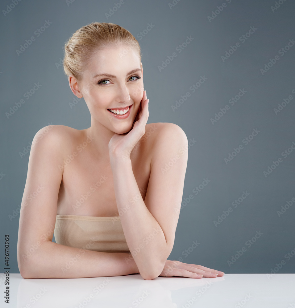 Beauty in simplicity. Studio portrait of a young woman with beautiful skin isolated on gray.