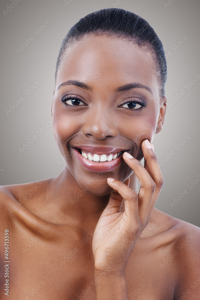 Beauty with a smile. Portrait of a beautiful african american woman touching her skin.