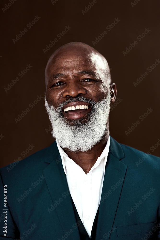 Staying positive is whatll help you win. Studio shot of a mature businessman posing against a brown 