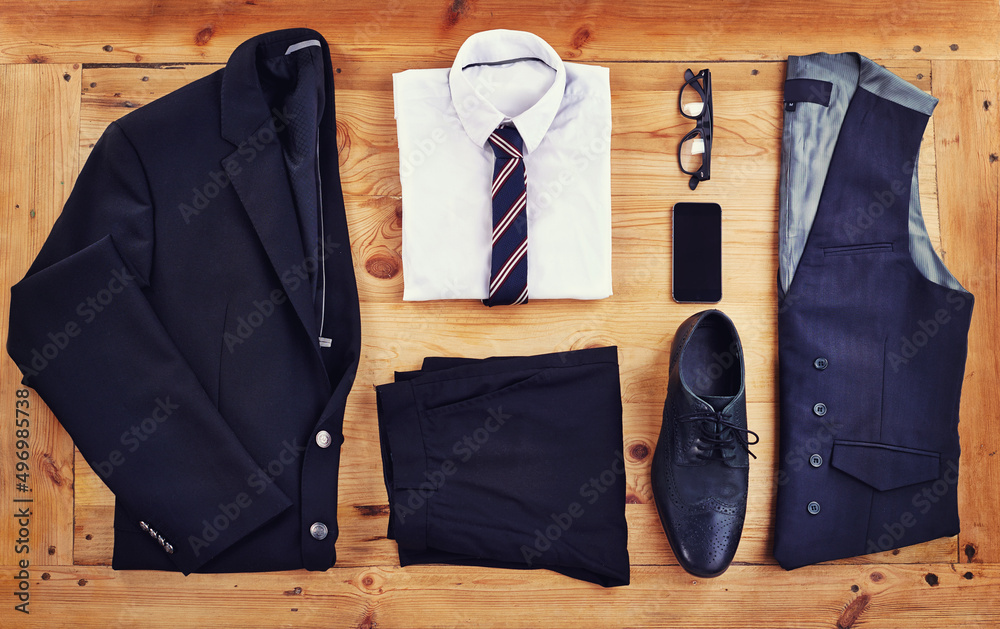 Time to look sharp. High angle shot of a stylish business outfit with a smartphone laid out on a woo