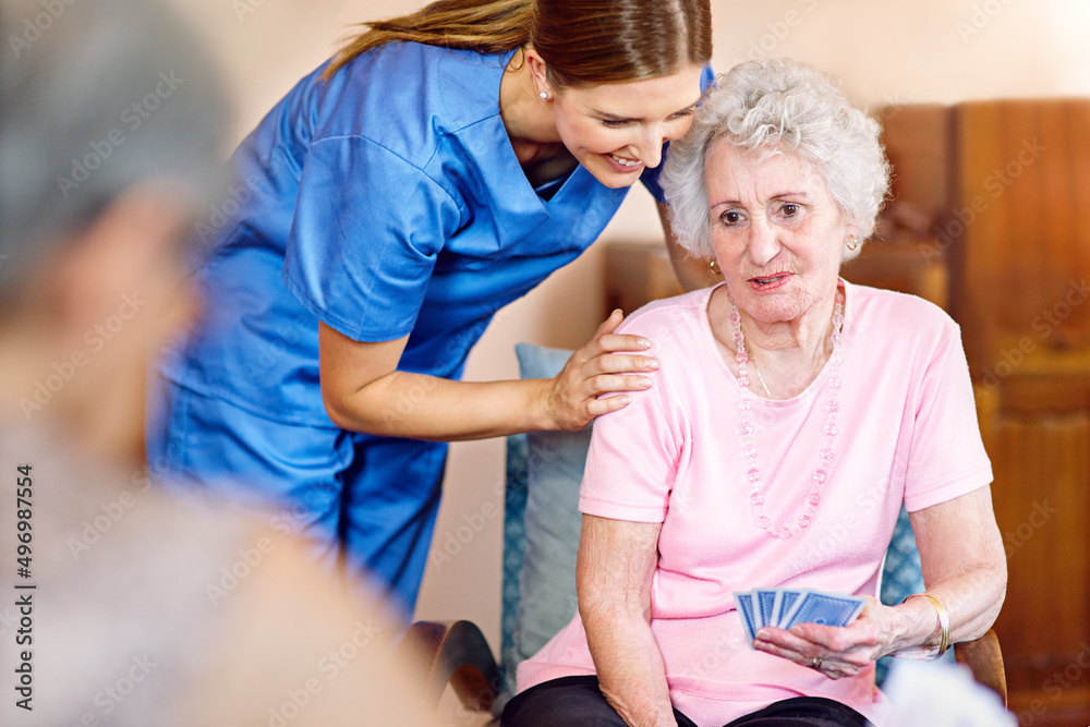 Youve got this. Cropped shot of seniors playing cards in their retirement home.