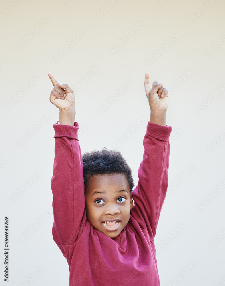 I have something for the kids. Shot of an adorable little boy standing against a white background.