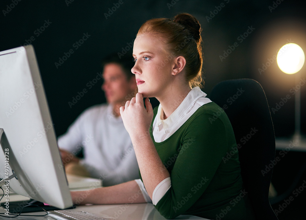 Working hard to make the deadline. Shot of a young businesswoman working on a computer in an office 