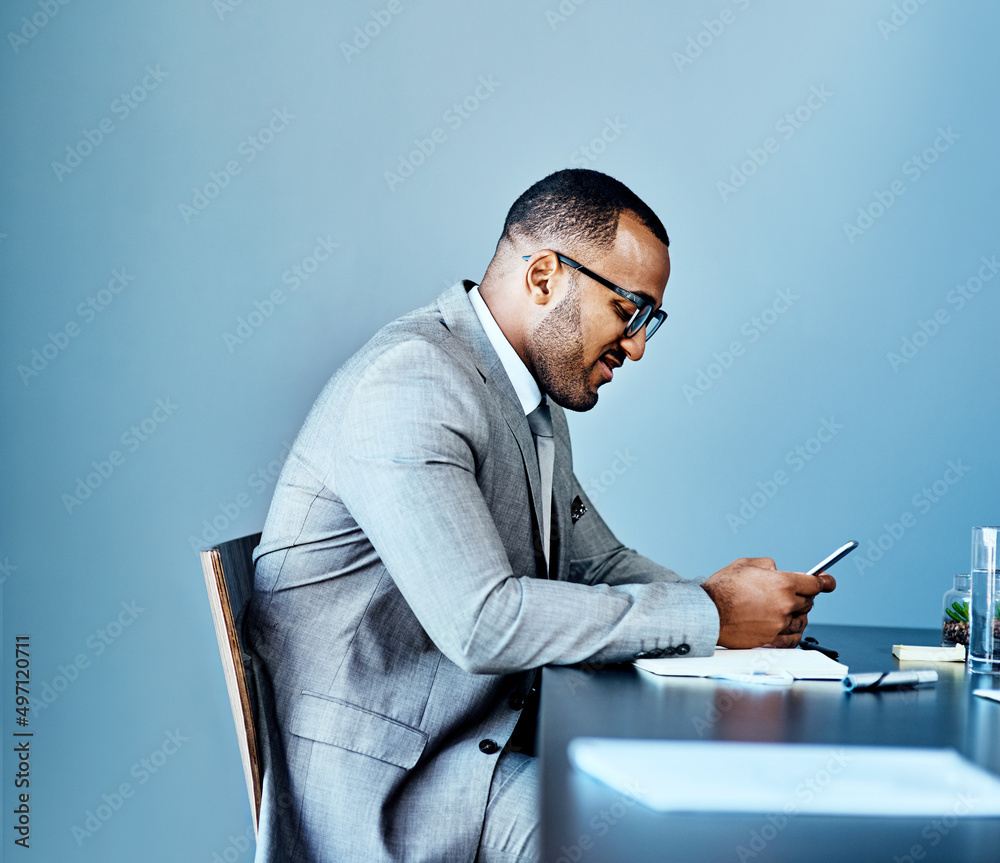 I am always networking. Cropped shot of a handsome young businessman sitting alone in his office and