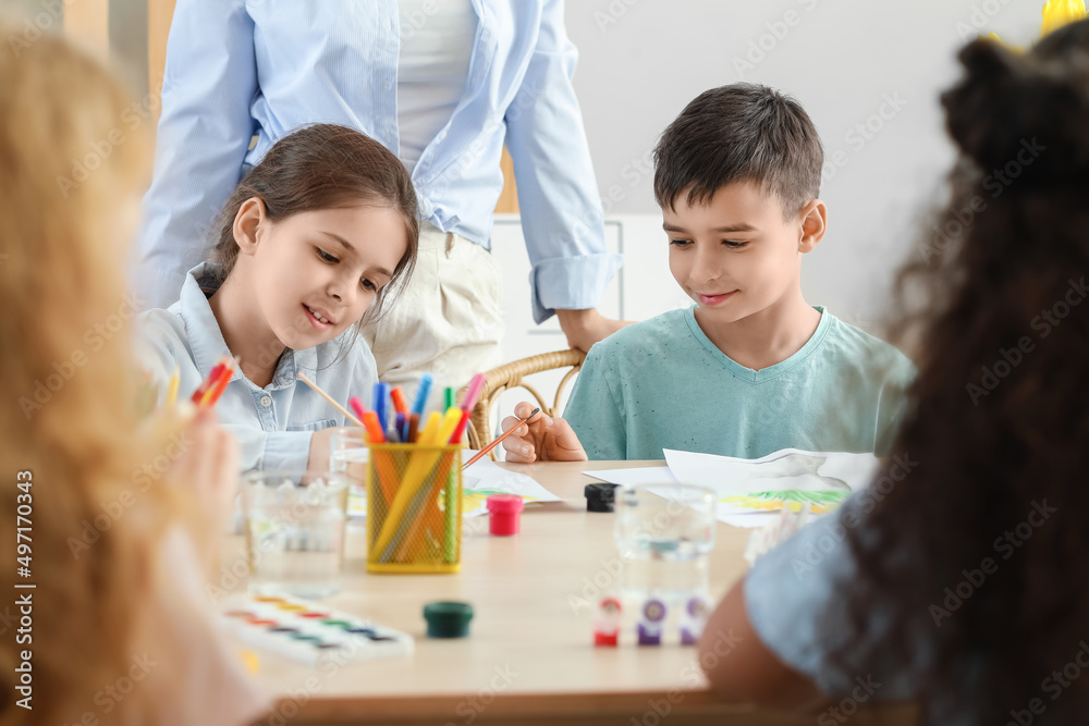 Cute children painting during master-class in art