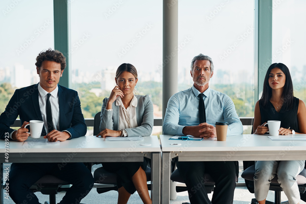 They here to interview you. Cropped shot of corporate businesspeople sitting in a row ready to inter