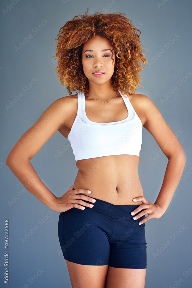 Strive for progress not perfection. Cropped shot of a sporty young woman posing against a grey backg