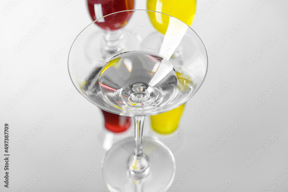 Martini glass with water on light background