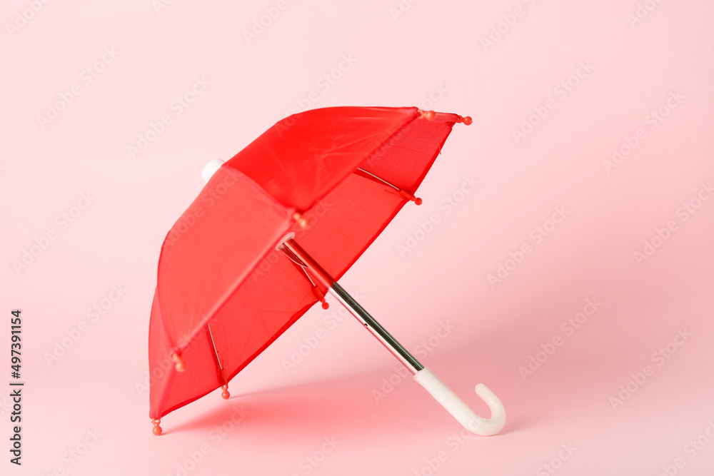 Red umbrella on pink background