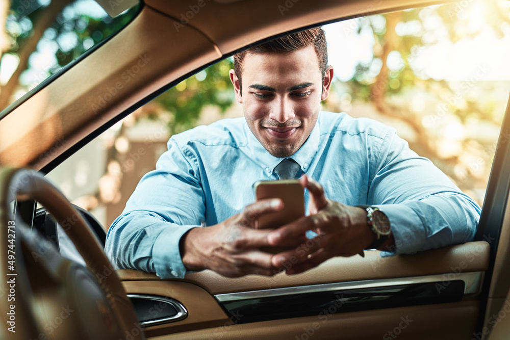 Staying close to his network even when on the go. Shot of a young businessman using a cellphone whil