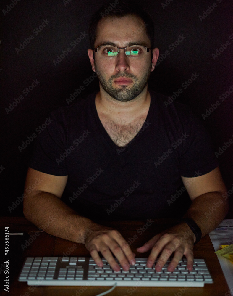 Committed to meeting his deadlines. Cropped shot of a young man working late in his office.