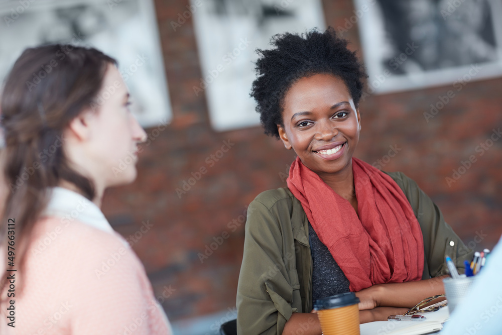 Were going for the A. Portrait of a young university student sitting in her classroom during a group