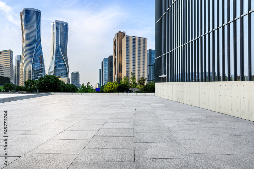 Empty square floor and city skyline with modern commercial buildings in Hangzhou, China.