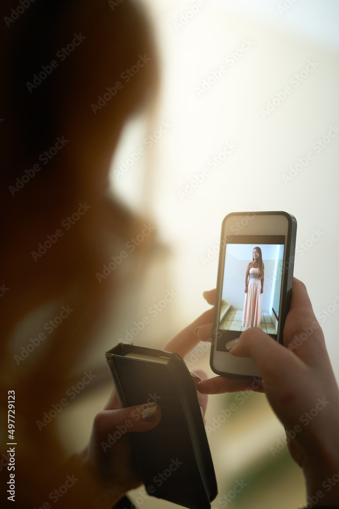 Tell me what you think.... Shot of an unrecognizable young woman looking at a photo on her cellphone