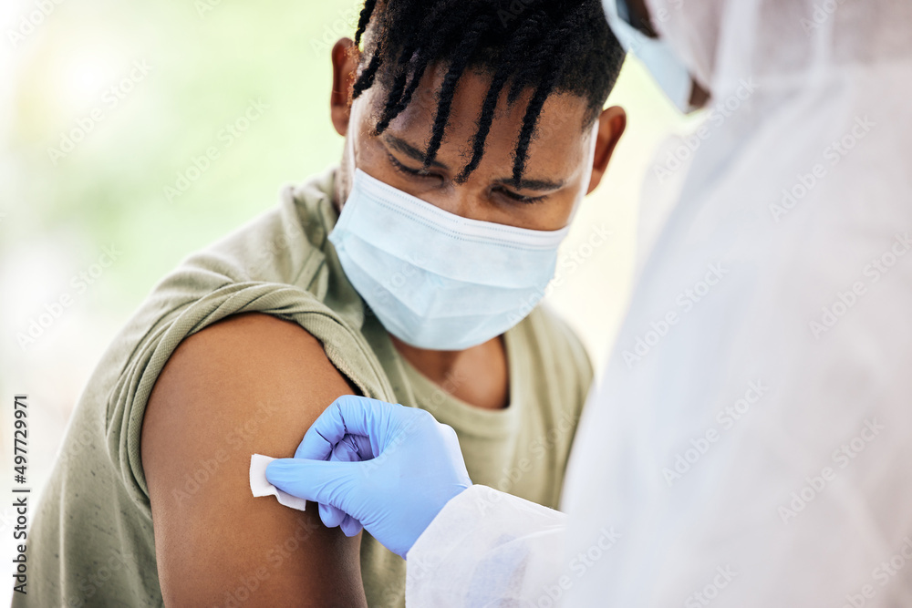 Cleaning the injection site. Cropped shot of an unrecognizable doctor cleaning the injection site of