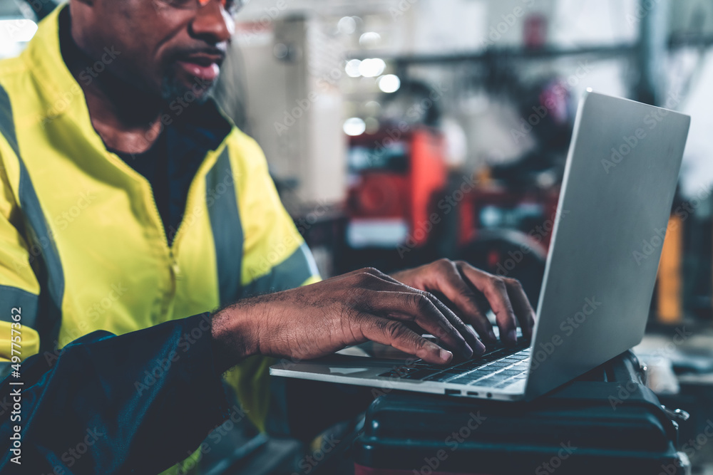 Factory worker working with laptop computer to do adept procedure checklist . Factory production lin