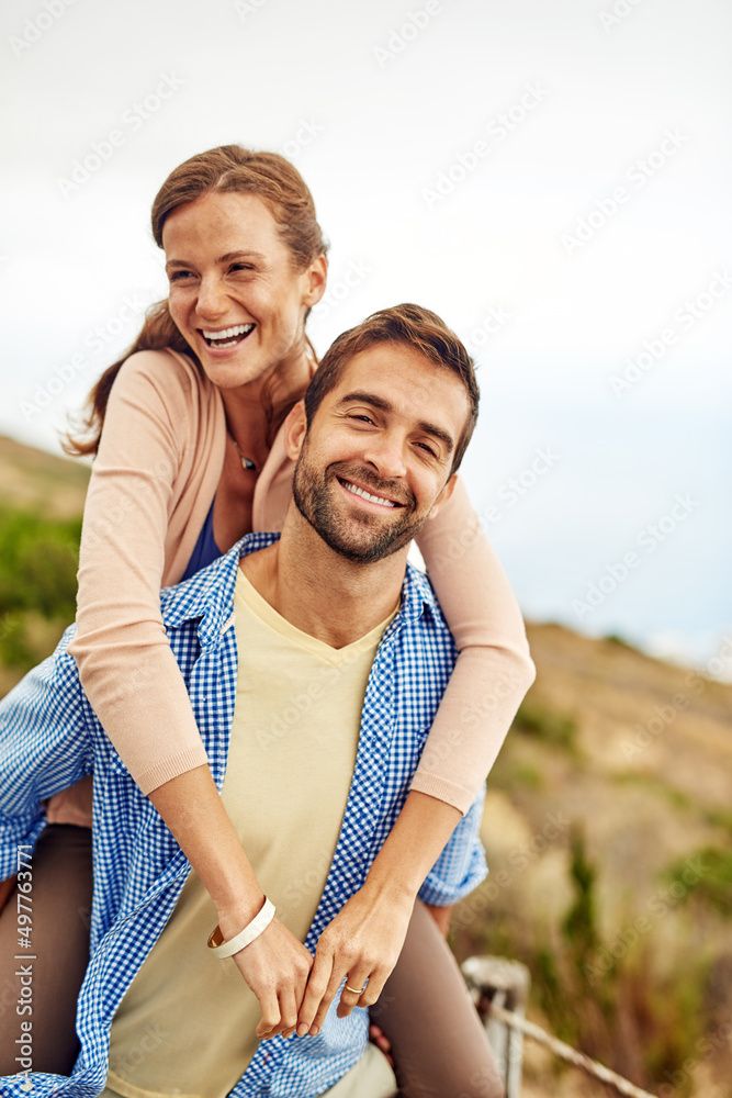 Were having such a good time together. Cropped shot of a man piggybacking his girlfriend while spend