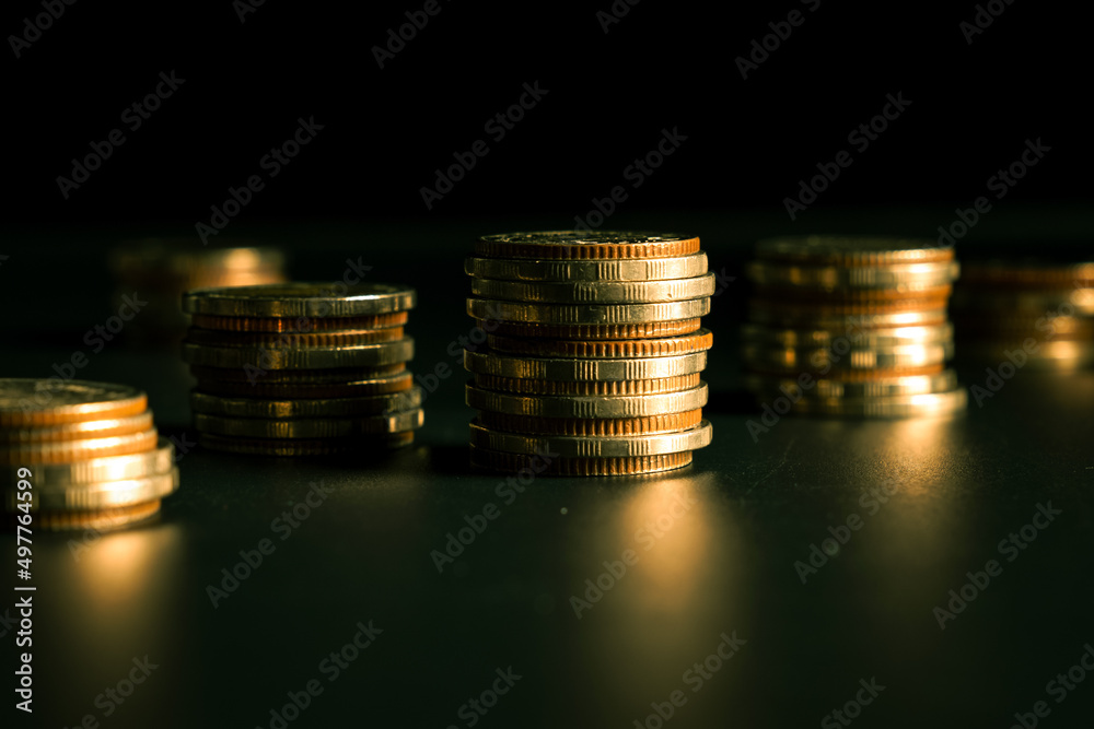 Pile of gold coins stack in finance treasury deposit bank account for saving . Concept of corporate 