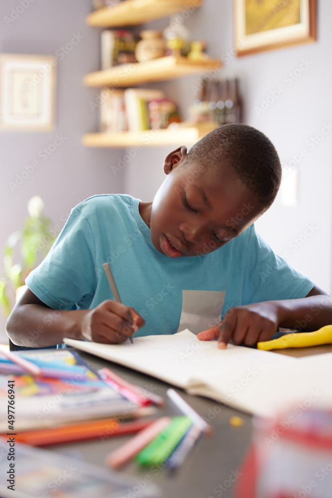 I could spend all day colouring in pictures. Shot of a young boy spending his time colouring in pict