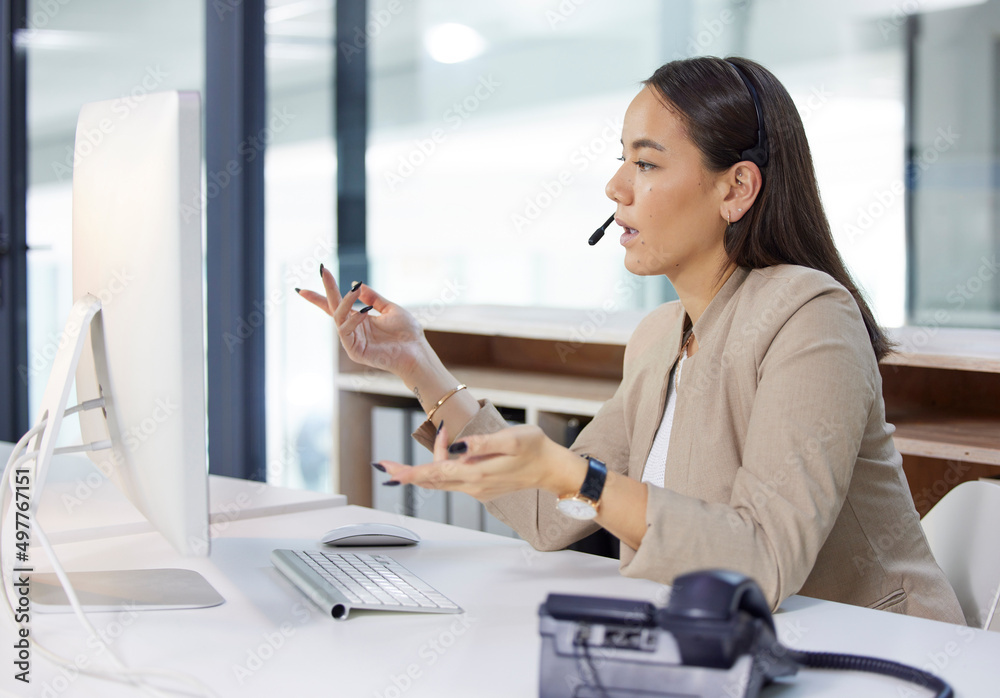 Ill have that corrected for you right away. Shot of a young woman using a headset and computer in a 