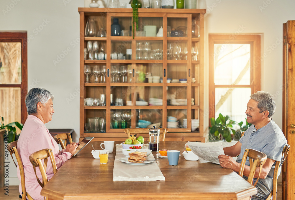 Can you please pass the salt. Shot of a cheerful elderly couple having breakfast together around a t