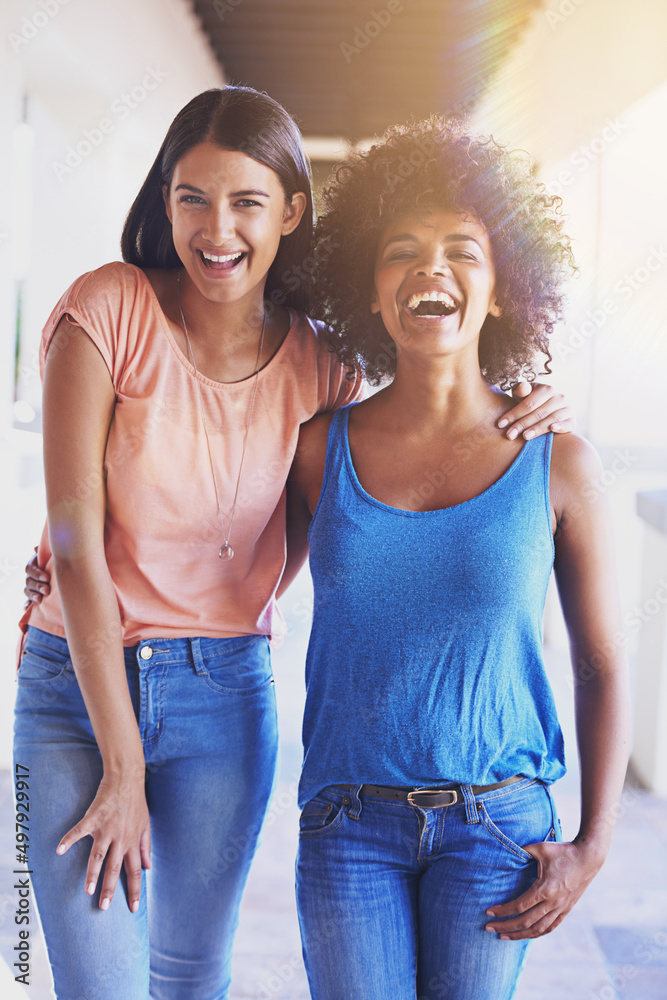 Sharing the love, sharing the laughs. Shot of two girlfriends hanging out together.