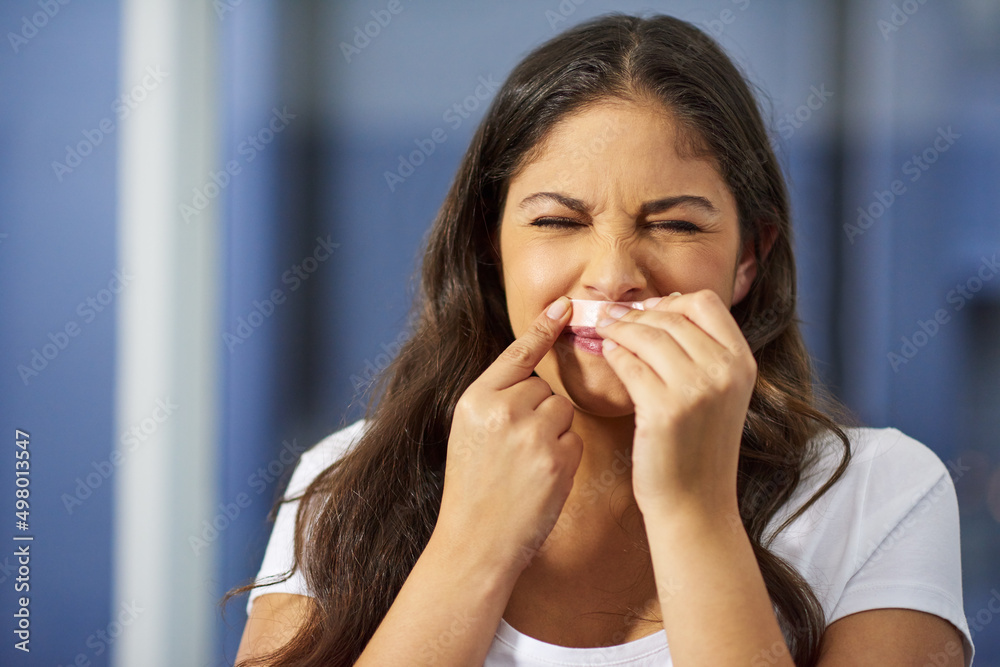 Getting rid of unwanted hair can be painful. Shot of an attractive young woman getting ready in her 