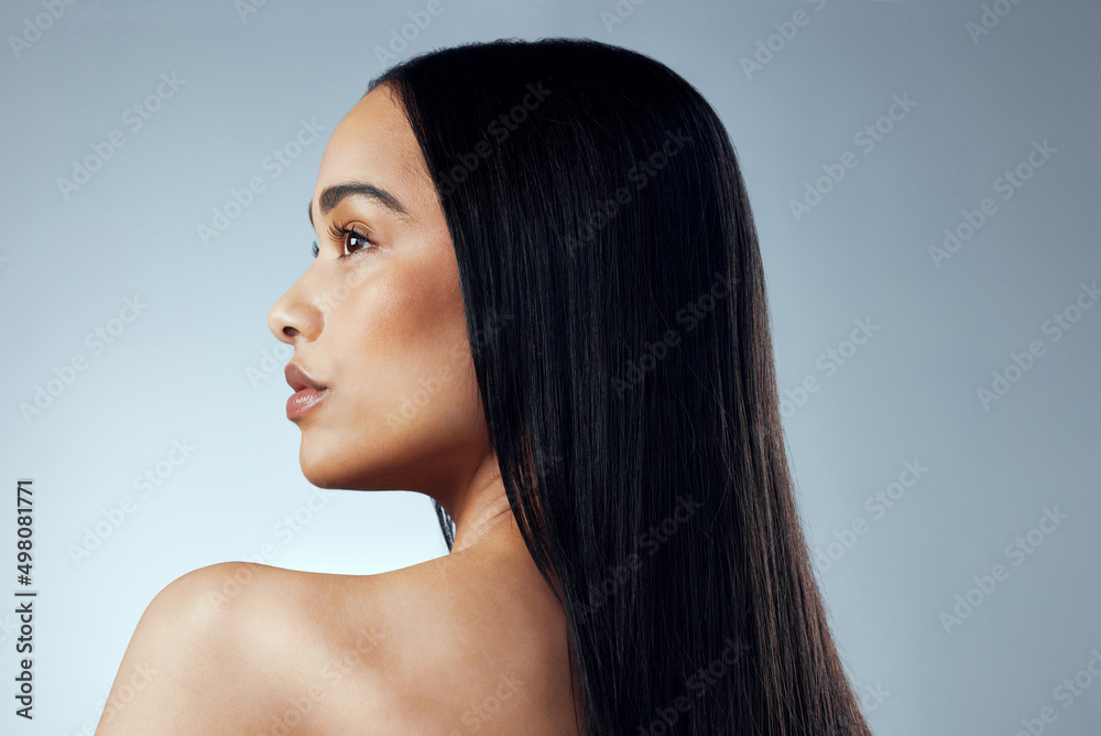 A great hairstyle is the best accessory. Studio shot of an attractive young woman posing against a g