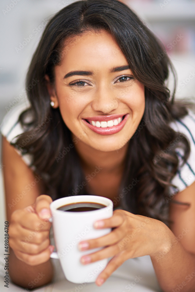 Get some coffee and get relaxing. Cropped portrait of a young woman drinking coffee while relaxing o