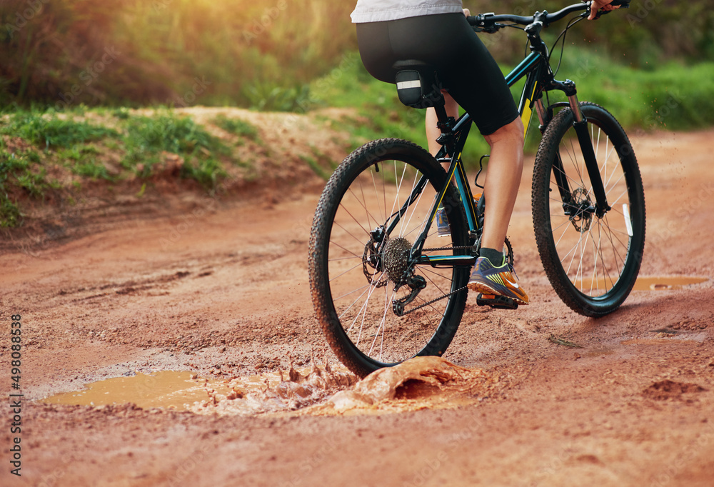 What an exhilarating hobby. Shot of a female mountain biker out for an early morning ride.