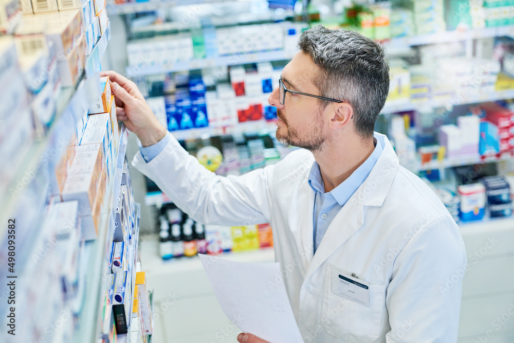 We have what the doctor prescribed. Shot of a mature pharmacist working in a pharmacy.