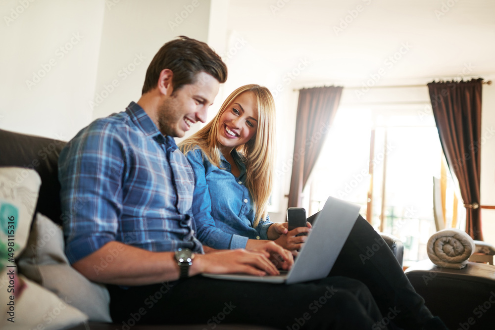 Spending a couple of hours online. Cropped shot of an affectionate young couple surfing the net whil