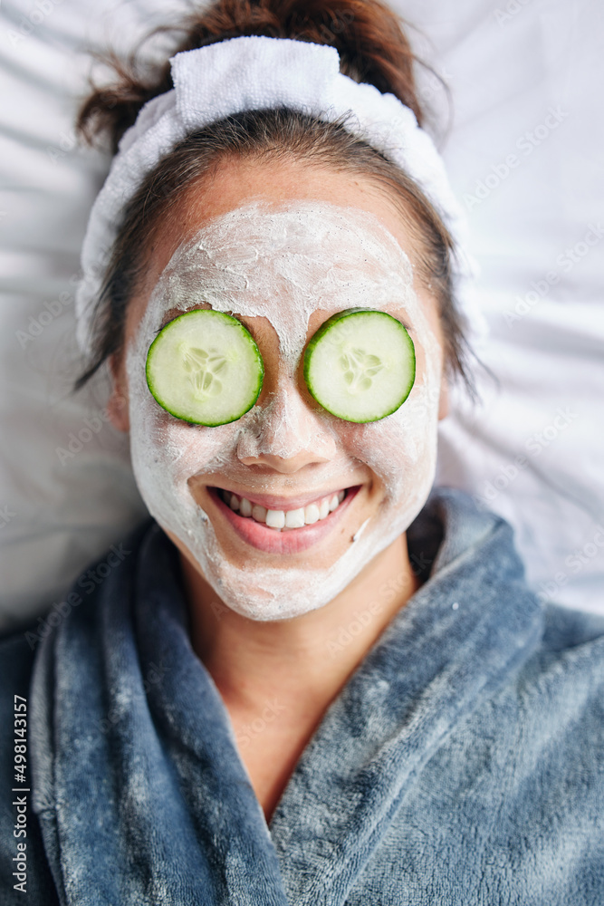 At home spa day. Shot of a young woman lying down with a beauty facial treatment on her face.