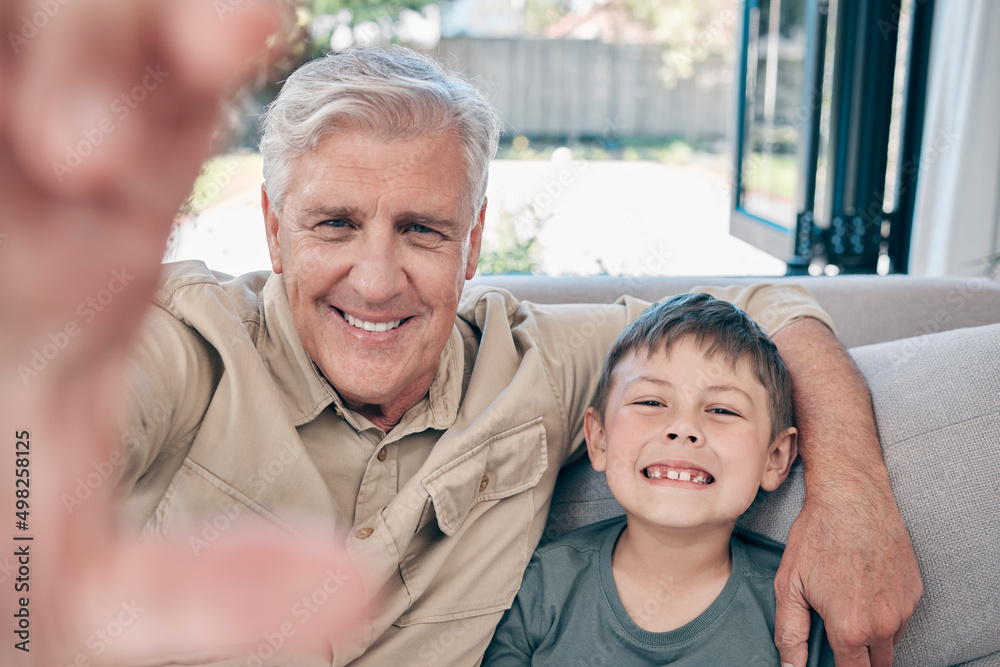 Theres no place like home, except at grandpas. Shot of an adorable little boy taking selfies with hi