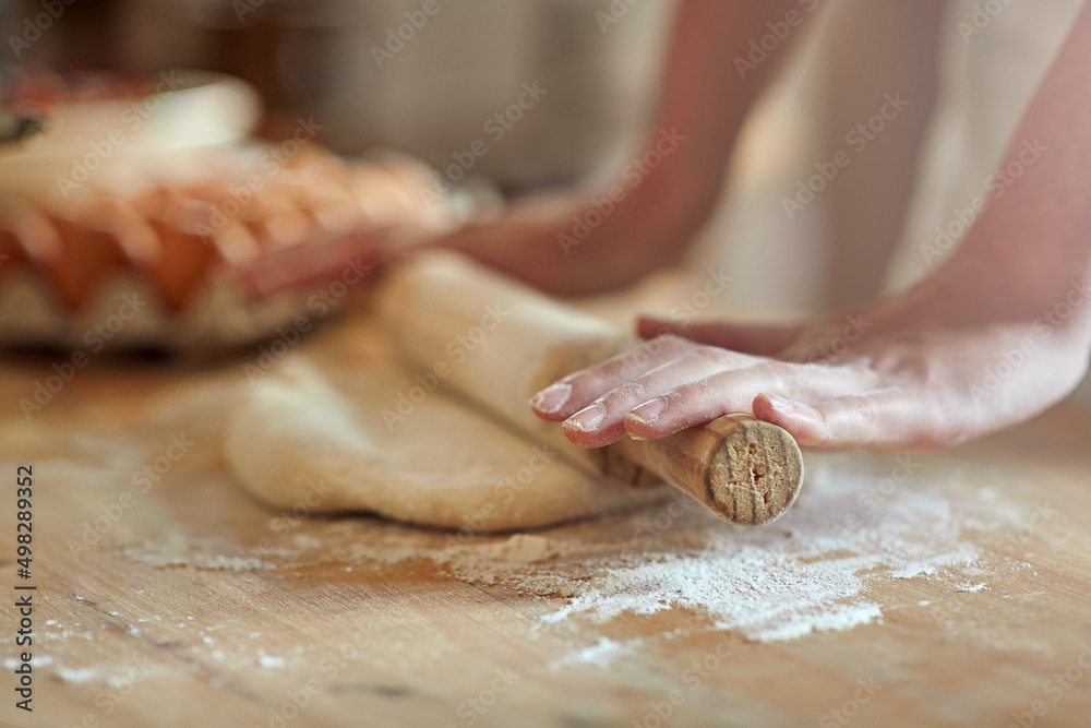 Get rolling. Cropped shot of a set of hands rolling out dough.