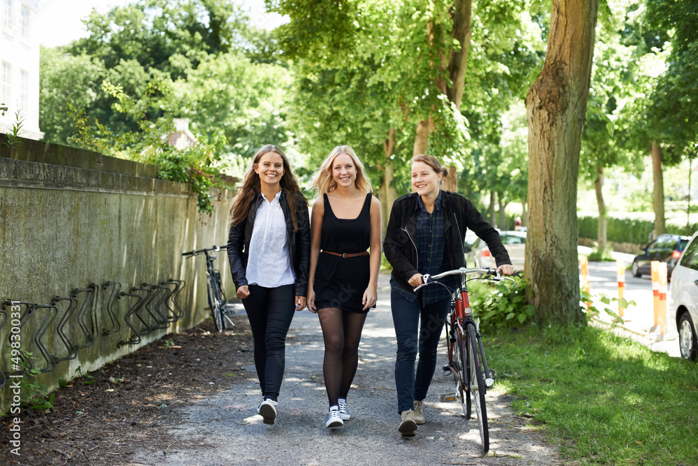 Catching up after school. Three friends walking home from school.