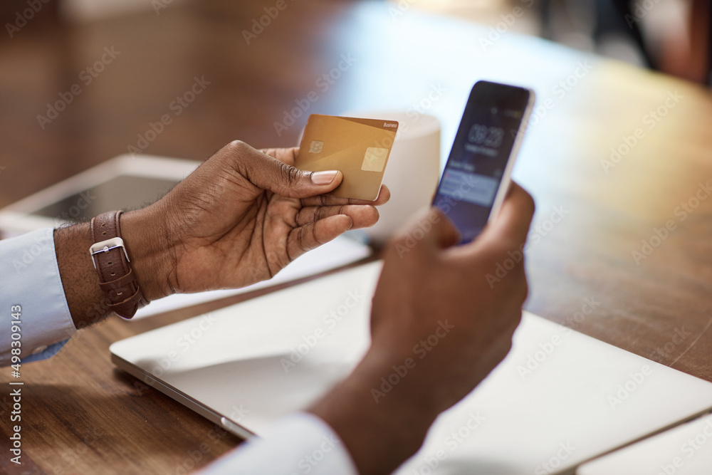 Banking made simple. High angle shot of an unrecognizable businessman banking on his mobile phone.