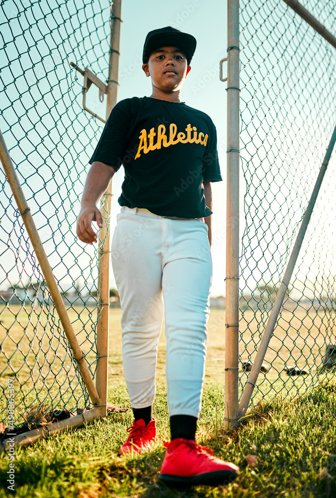 I left it all on the field today. Shot of a young baseball player walking through a gate.