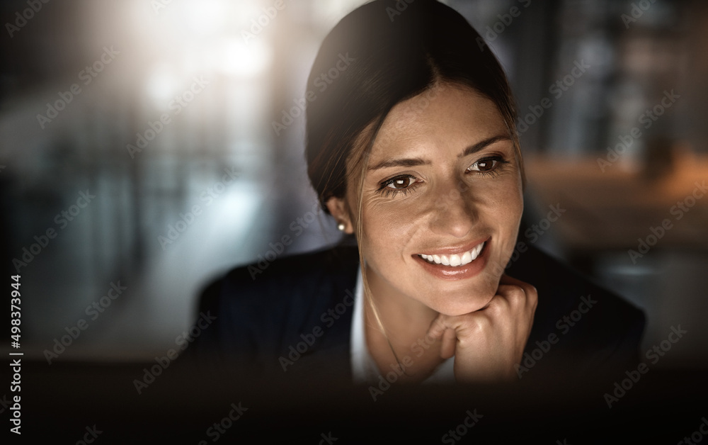 Smashing goals like the pro that she is. Shot of a young businesswoman working online during a late 