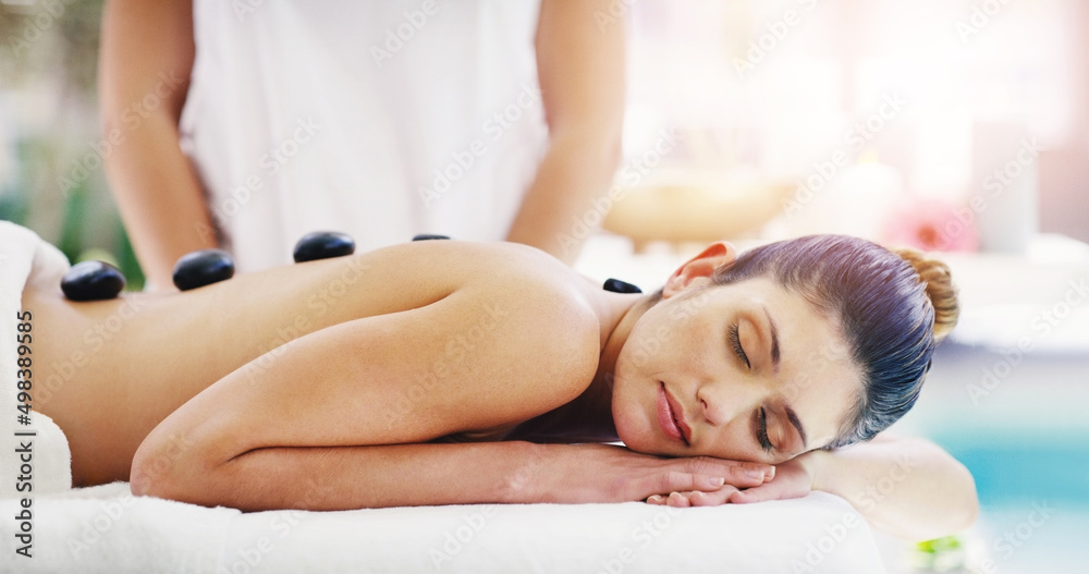 These stones will work out all your tension. Shot of a young woman getting a hot stone massage at a 