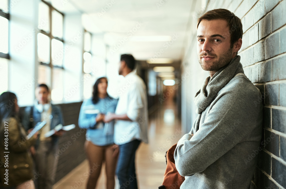 Campus life suits me. Cropped portrait of a handsome male university student standing with his arms 