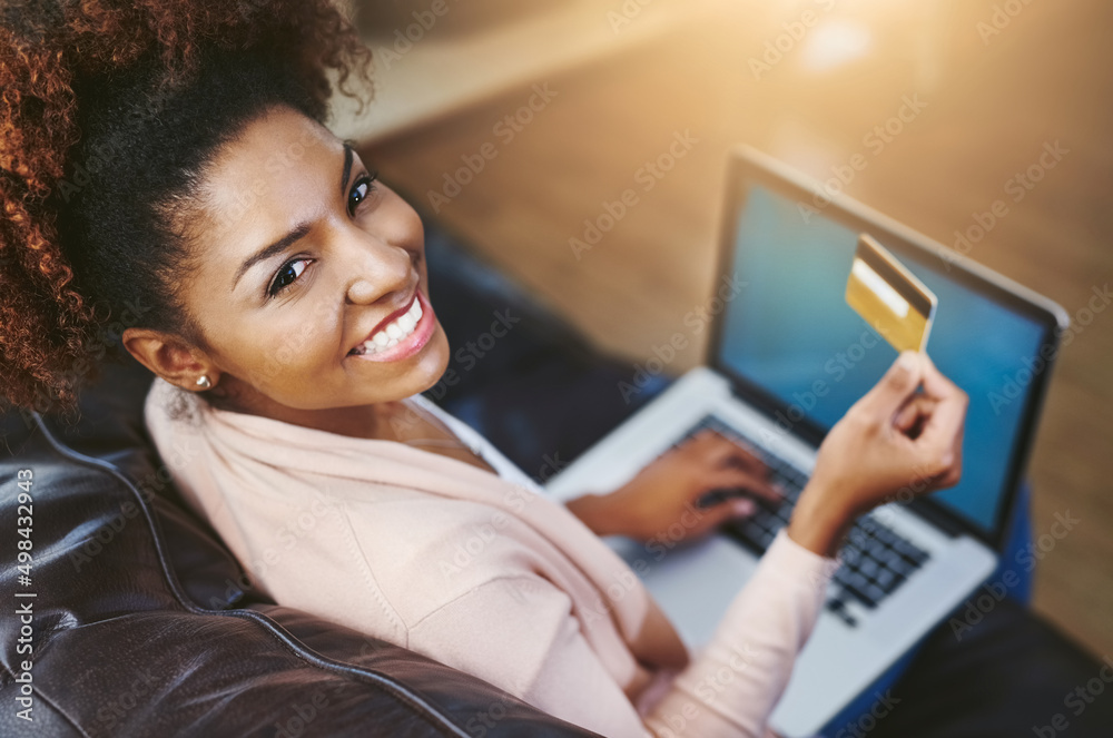 Shopping has never been easier. High angle portrait of an attractive young woman shopping online whi