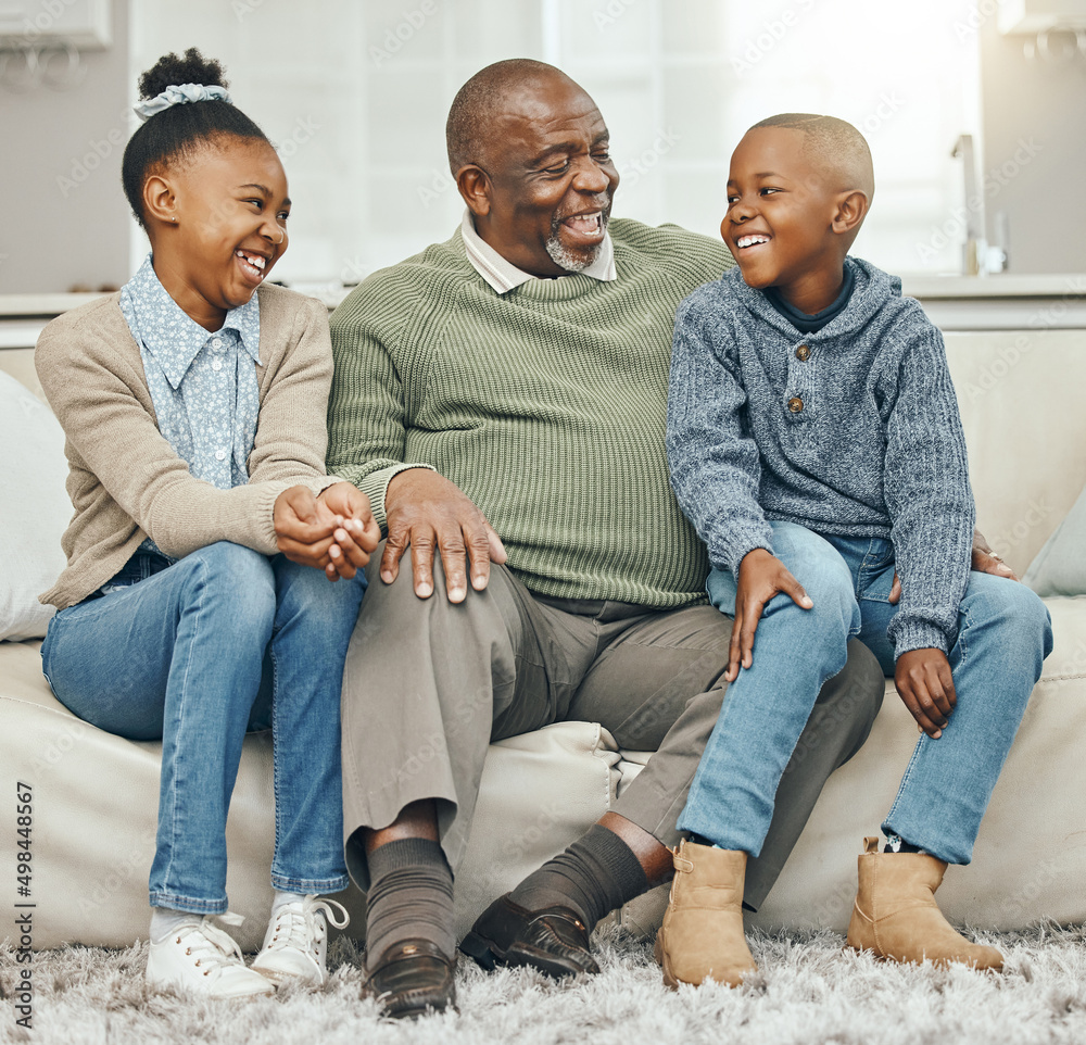 Thats how we did things back in the day. Shot of a grandfather bonding with his grandkids on a sofa 