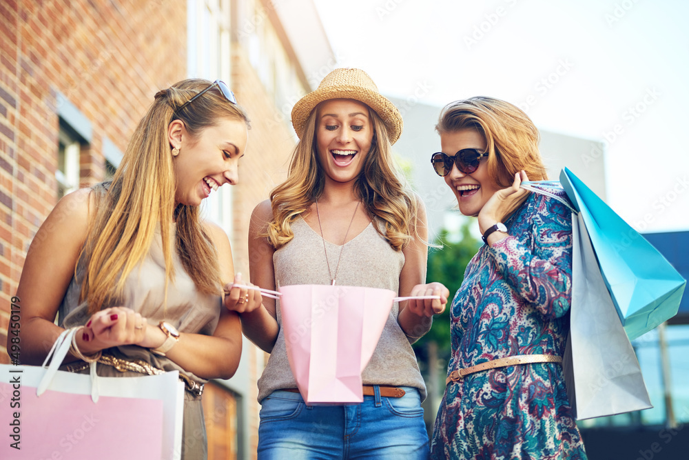 Check at all these great things I got. Cropped shot of three young girlfriends shopping in the city 