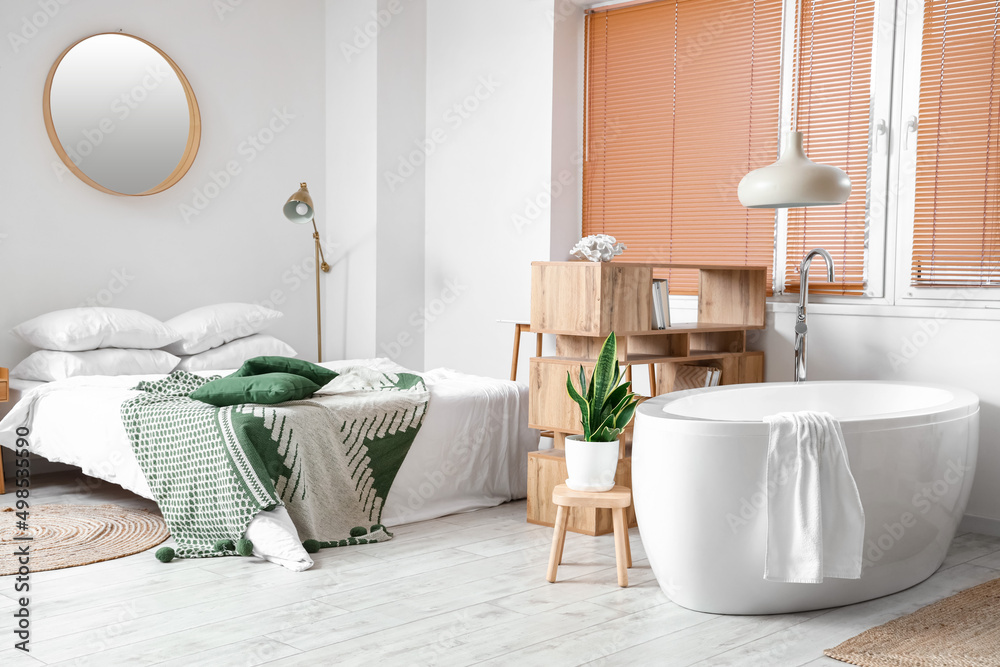 Interior of modern bedroom with bathtub