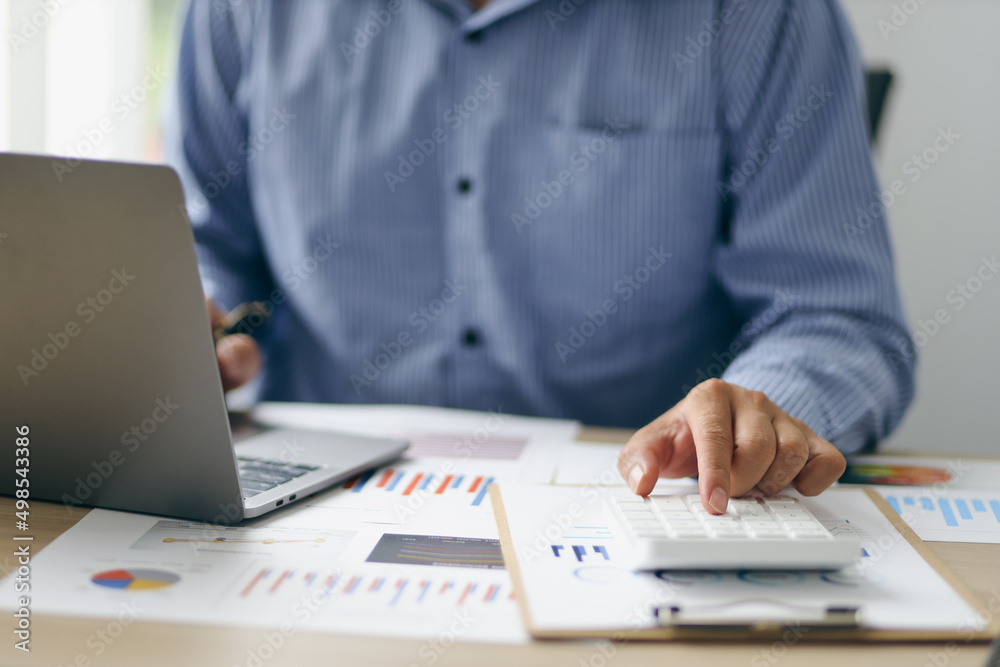 Accounting businessman working on laptop computer and analyzing real estate investment data, Financi