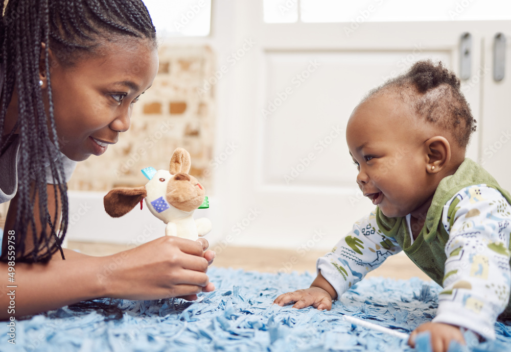 Tummy time is fun time. Shot of a young woman bonding with her baby at home.